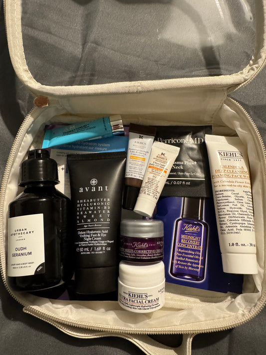 A collection of skincare products including serums, moisturizers, and sunscreens, displayed in an open makeup bag.